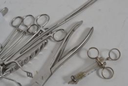 A collection of vintage medical doctors surgical operation tools to include syringes, bone