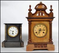 A late 19th century marble and slate mantel clock together with an eight day mantel clock set within