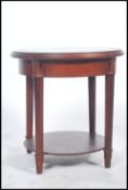 A 20th century circular Bijouterie Cabinet having a montage display to the centre of a river bed