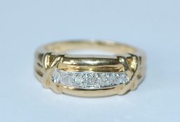 A hallmarked 9ct gold and diamond half eternity band ring with channel set diamonds and kiss cross
