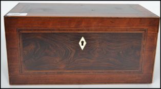 A 19th century Georgian mahogany and coromander twin barrel tea caddy being cross banded with