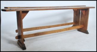 A near pair of 19th century French rustic pine refectory pig benches. Each with shaped single