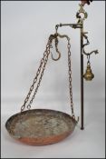 An early 20th century set of brass scales - hanging scales complete with the pans and chains.