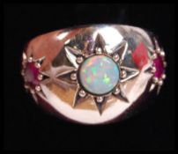 A silver opal and garnet stone adorned 3 stone gyp