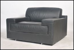 A retro 20th century black leather Italian made modernist armchair with influences of Le  Corbusier,