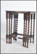 A 20th century tall oak nest of three tables havin