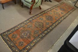 An early 20th century Iranian Persian Hamadan runner - rug having blue borders with medallions to