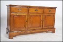 An 18th century Georgian style mahogany dresser base raised on bracket feet having a series of short