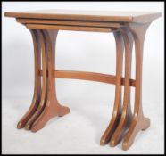 A nest of three G-Plan teak occasional tables, the rectangular tops on inverted T-shaped supports