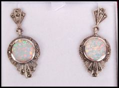 A pair of Art Deco style silver, marcasite and opal adorned ladies earrings complete in the