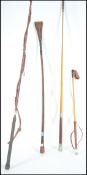 A group of vintage horse riding crops to include a silver hallmarked leather example bearing