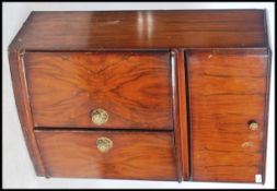 A 1950's  cocktail cabinet bar raised on shaped legs with metamorphic top having an appointed