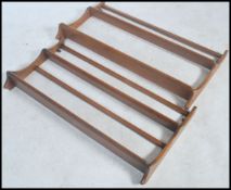 A pair of 20th century Golden Dawn two tier Ercol plate racks Each with applied blue Ercol sticker