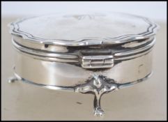 An Edwardian silver pill pot with fitted hinged lid raised on tripod feet, Birmingham assay marks