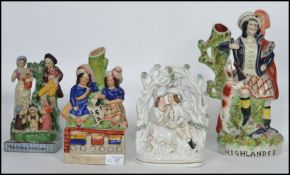 A good group of 19th century Victorian Staffordshire ceramic flat-back figurines to include a seated