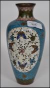 A 20th century Oriental cloisonne vase having a blue ground with waisted neck and white cartouche