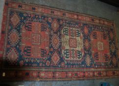 An early 20th century Persian Caucasian rug having gemoetric borders with multiple medallions to the