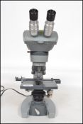 A 20th century A. O Spencer of Buffalo USA binocular microscope with three objectives. Measures 40cm