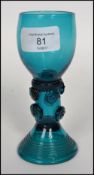 A Georgian Bristol blue roemer wine glass raised on a tubed spiral base with coiled green stem