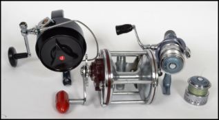 A group of vintage fishing rod reels to include a Penn Senator 60 6/0 boat rear sea fishing reel