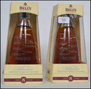 A pair of Bells whisky millennium decanters complete in original boxes.