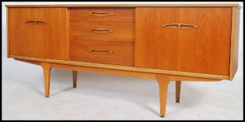 A retro 20th century teak wood long sideboard having a central bank of three drawers flanked by a