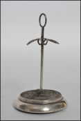A hallmarked silver hat pin stand of plain design with a hoop top, with a pierced platform to