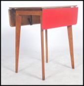 A vintage mid 20th century red topped Formica dining drop leaf table of smaller proportions raised