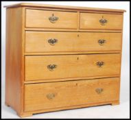 A Victorian country pine 2 over 3 chest of drawers having a flared top with brass drop handles to
