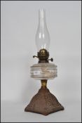 An early 20th-century duplex oil lamp having a flute raised above a faceted reservoir on top of a