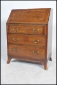 A 20th century mahogany Georgian revival bureau desk being raised on French kick legs with a blind