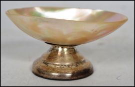 An early 20th century Edwardian hallmarked silver and mother of pearl eye bath / salt having a two