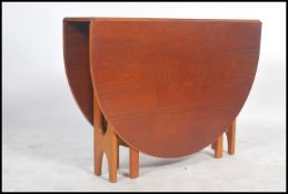 A retro 20th century G-Plan teak drop leaf dining table having splayed foot frame, the end leaves