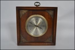 A 20th century square wooden cased mantel clock wi