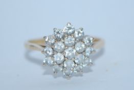 A hallmarked 9ct gold and white stone cluster ring. Hallmarked London. Size Q. Weight 2.9g.