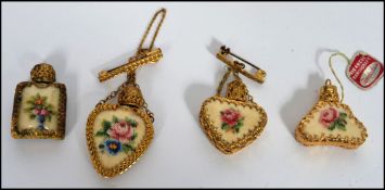 A collection of four miniature gilt metal brooch perfume bottles retained within a gilt and mother