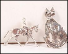Two 20th century silver brooches, one in the form