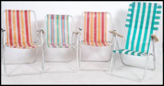 A collection of retro 20th century deck chairs to include 2 aluminium frames. Each with stripe