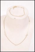 A matching 9ct gold and pearl bracelet and necklace set, the chains interspersed with real pearls.