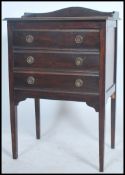 An Edwardian mahogany pedestal music cabinet having a series of fall front drawers with a gallery
