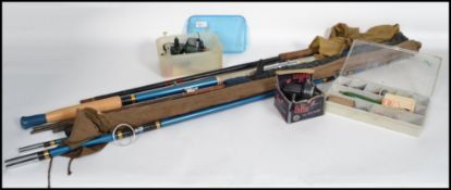 A  good collection of vintage 20th century fishing rods reels and equipment to include early 20th