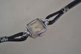 An early 20th century ladies Omega dress / cocktail watch having gold baton numerals with gold