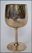 A hallmarked silver goblet raised on a plain base with tapering stem and bell shaped bowl to top.