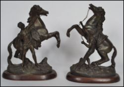 After Guillaume Coustou, a pair of ' The Horse Tamer ' spelter figures, depicting men breaking