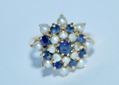 A hallmarked 9ct gold and sapphire and pearl cluster ring. Hallmarked London. Size M. Weight 4.4g.