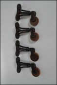 A set of four large 20th century retro industrial trolley wheels of cast metal construction with