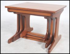 A set retro 20th century teak wood Danish influenced nest of three inter-sliding occasional