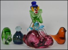 A collection of 20th century studio glass to include a Murano clown, Wedgwood paperweights to