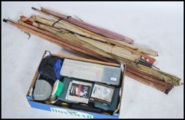 A large collection of vintage and retro fishing equipment to include cane and fibre fishing rods (