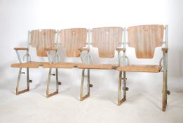 A set of four vintage 20th century cinema chairs. Set on a metal tubular frame having wooden flip up